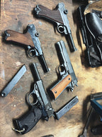 Multiple guns on a wooden surface