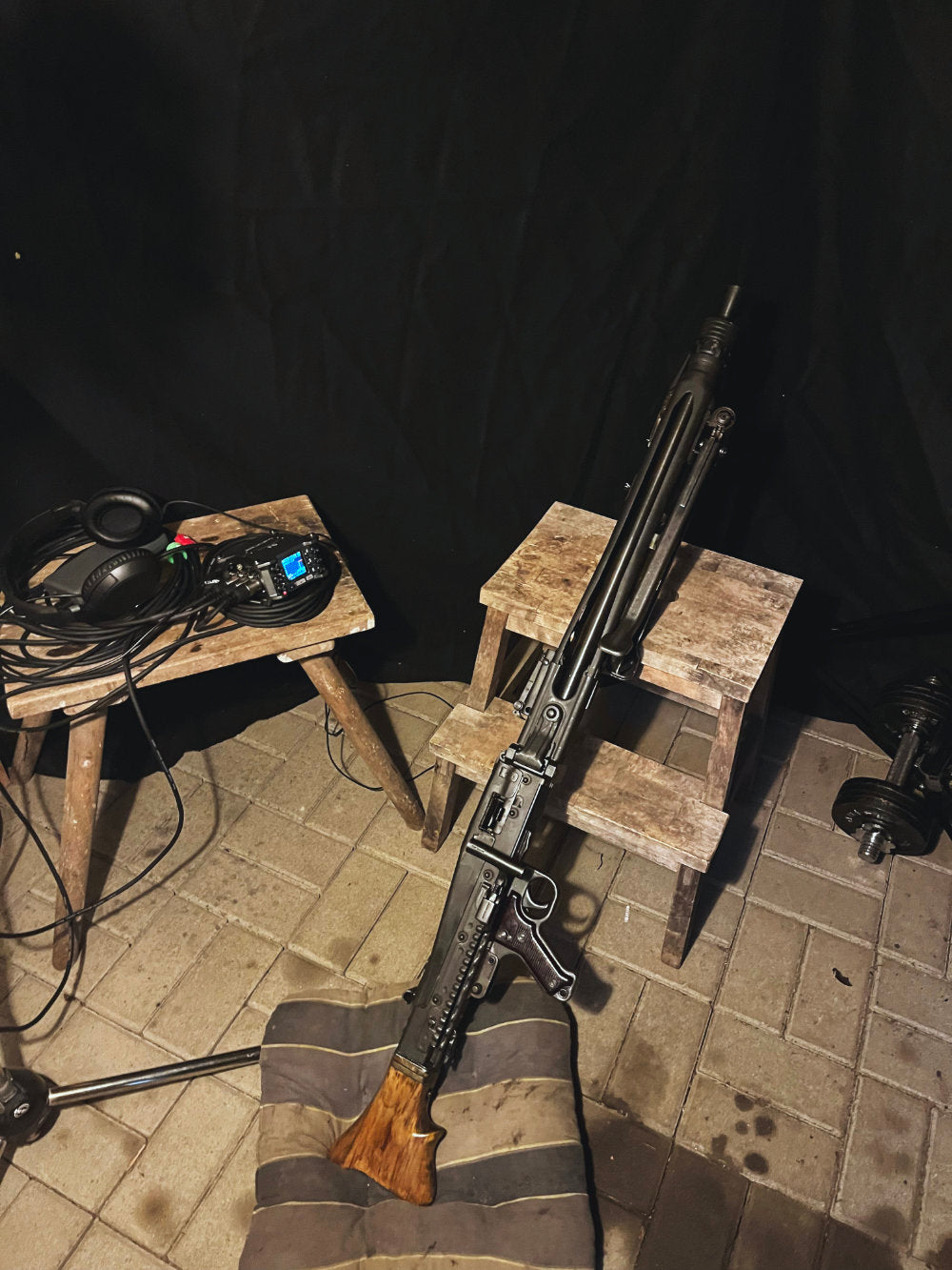 Rifles on wooden stands with a black background