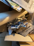 Stack of newspapers and cardboard boxes on a surface