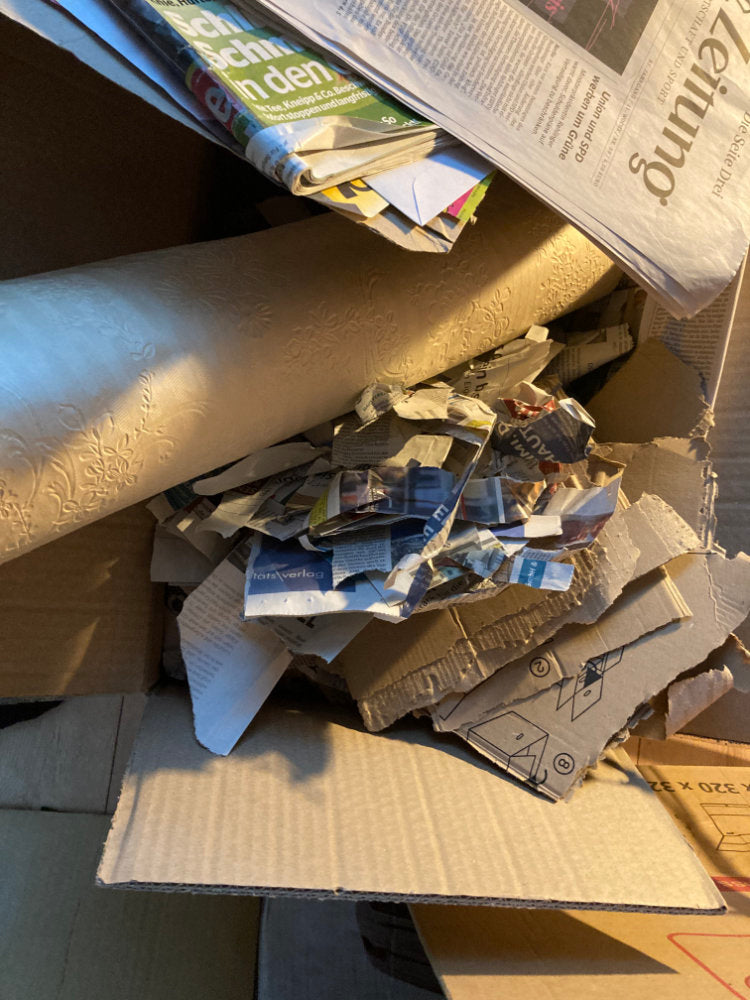 Stack of newspapers and cardboard boxes on a surface