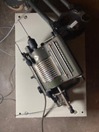 Industrial machine or equipment on a flat surface with visible branding