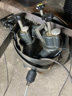 Close-up of a mechanical component, possibly a brake or clutch system, on a concrete surface.