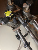 Close-up of mechanical parts with a yellow tag on a metallic background